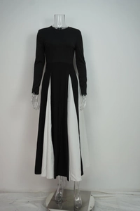 Close-up of elegant black and white patchwork maxi dress with long sleeves and round neck