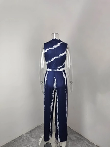 Back view of navy blue sleeveless jumpsuit with white tie-dye stripe print on mannequin