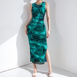Detail of emerald green marbled print dress featuring side ruching and a high leg slit