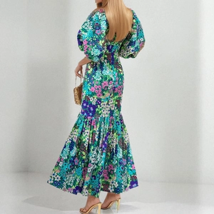 Rear view of floral bubble sleeve dress showing a slender waist and elegant fishtail hemline