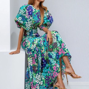 Elegant floral maxi dress with vibrant puff sleeves and a slim fit waist design
