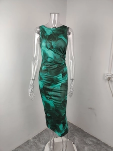 Detail view of ruched side seams and green floral print on sleeveless midi dress