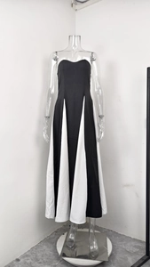 Detail of color-block dress showing black fabric with white triangular pleated inserts