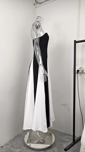 Detail of elegant black and white color block tube dress on a side view mannequin