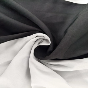 Detailed view of black and white color-block fabric texture with soft drape and smooth finish