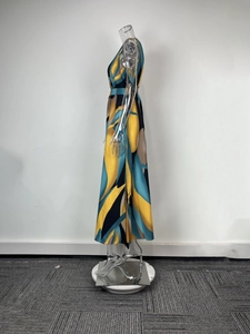 Detail view of abstract leaf print on elegant sleeveless maxi dress with a slim fit waist