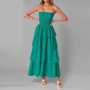 Detail of green strapless tiered maxi dress showing shirred bodice and layered skirt