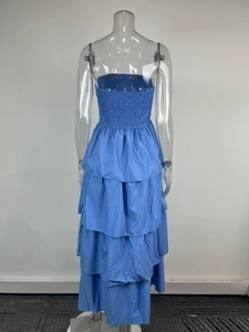 Detail of blue smocked strapless tiered maxi dress showing gathered fabric and layered hem
