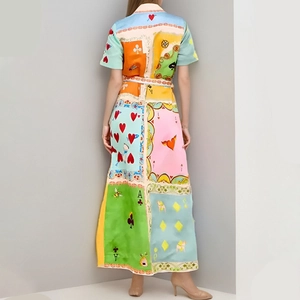 Detail of lapel neckline and colorful playing card print on a resort maxi dress