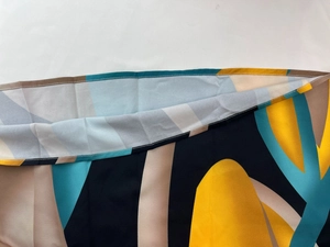 Detailed view of abstract print fabric and high-quality flat stitching on a sleeveless dress