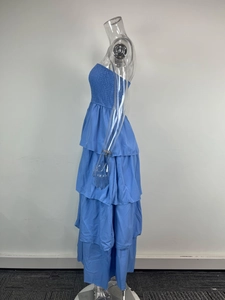 Detail of blue strapless tiered dress with elastic smocking and layered chiffon skirt