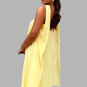 Detail view of the backless design on this elegant pale yellow sleeveless dress