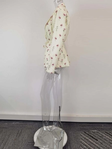 Side view of floral blazer with lapel collar and waist tie on a female mannequin