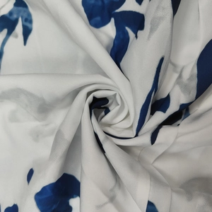 Detail of floral printed fabric with abstract navy blue ink patterns on white
