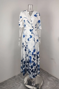 Close-up of V-neckline and blue ink print on white elegant long maxi dress