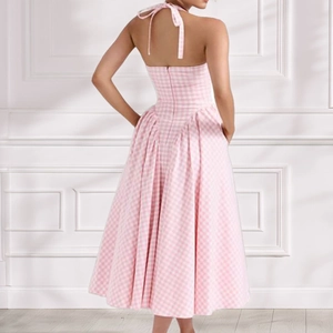 Elegant pink gingham halter neck midi dress with an open back and pleated A-line skirt