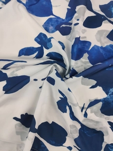 Macro detail of blue and white floral chiffon fabric showing soft drape and elegant texture