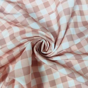 Close-up of pink and white gingham fabric with a soft texture in a spiral swirl arrangement