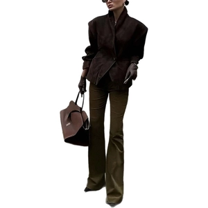 Women's professional dark brown blazer and trousers suit with matching leather gloves