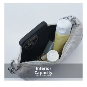 Quilted white shoulder bag showing internal capacity for phone and cosmetics