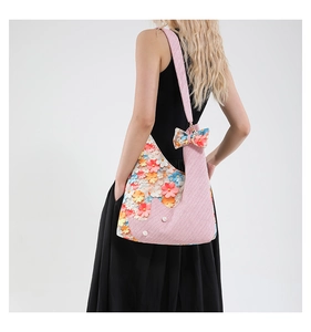 Detail of pink shoulder bag with 3D handmade floral appliques and pearl centers