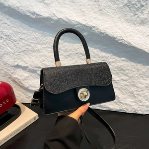 Retro black crossbody bag with shimmering silver sequins and a gold metal twist lock