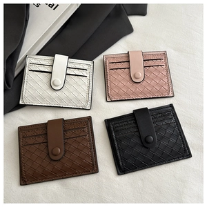 Detail view of woven leather card holders in four colors with a secure snap closure strap