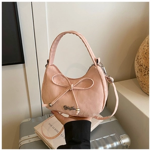 Detail of pink half-moon crossbody bag with bow decoration and silver metal logo