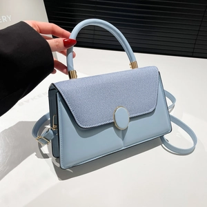 Light blue contrast flap handbag with gold metal lock and detachable shoulder strap