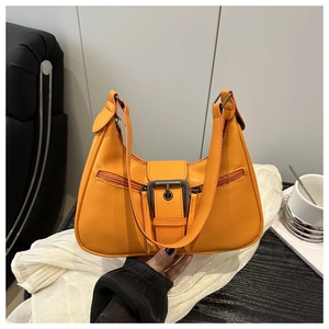 Detail of vintage orange dumpling bag with retro metal buckle and double zippers