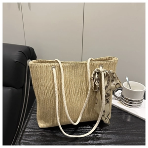 Detailed straw woven tote bag featuring thick cotton rope handles and a silk scarf accent