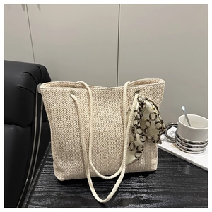 Detailed herringbone weave pattern on cream straw tote bag with rope handles and silk scarf