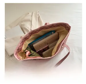 Pink tote bag interior showing large capacity for umbrella, notebook, and wallet