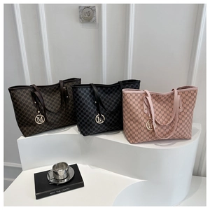 Close-up of stylish large tote bag sets with M monogram pattern in three colors