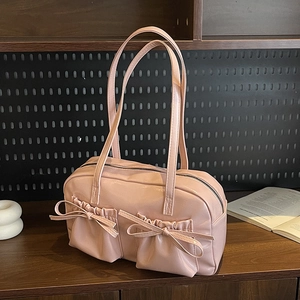 Pink balletcore shoulder bag with bow pleated pockets and long top handles in a retro style