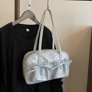 Glossy light grey underarm bag with pleated pockets and ribbon bow details