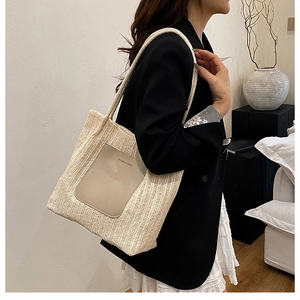 French style beige straw tote bag featuring a leather pocket and thick woven strap