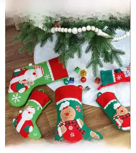 Detail of Santa and Gingerbread Man embroidery on red and green Christmas socks