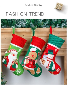 Detail of Christmas stockings with Santa and Gingerbread Man hanging on a fireplace