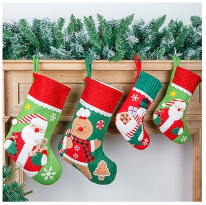 Close-up of four embroidered Christmas stockings with Santa and snowman on a mantel