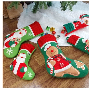 Detailed close-up of embroidered Santa and Gingerbread man Christmas stockings on tree skirt