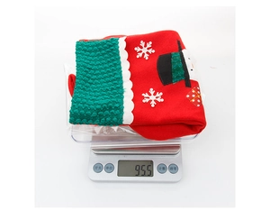 Christmas stocking gift bag with snowman embroidery weighed on a digital scale