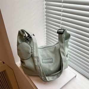 Light green corduroy tote bag with small round coin purse and wide shoulder strap