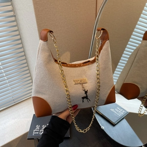 Retro canvas tote with brown leather trim, gold chain strap and deer charm pendant