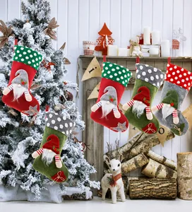 Detailed view of five festive gnome Christmas stockings with plush hats and white beards