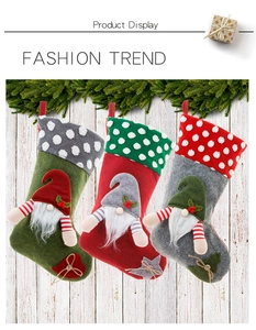 Detailed view of 3-pack Christmas gnome stockings in red, green, and grey flannel