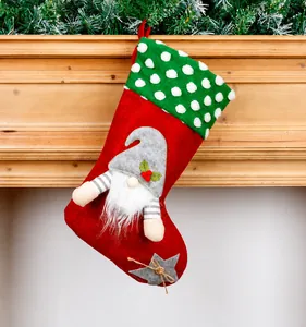 Detail of red Christmas gnome stocking hanging on a rustic wooden mantel with pine needles