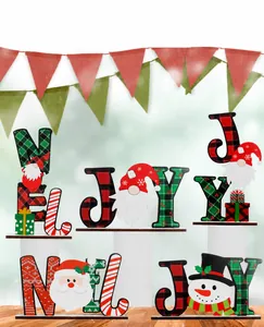 Close-up of wooden NOEL and JOY Christmas table decorations with festive gnome motifs