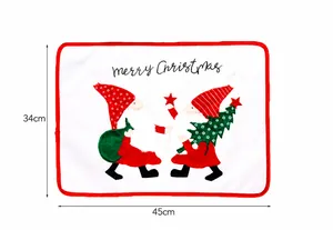 Detail view of 45x34cm white Christmas placemat with red border and embroidered gnomes