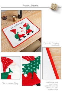 Macro detail of Christmas placemat with white embroidery and festive red stitched borders